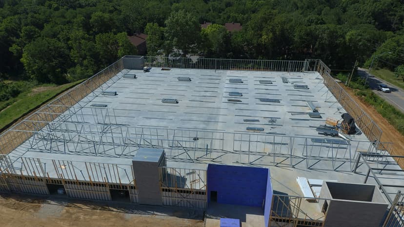 Construction site with concrete foundation and steel framework in progress