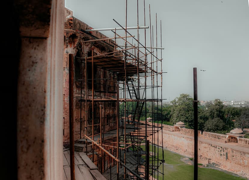 Interior of historic building being renovated with exposed brick walls and scaffolding