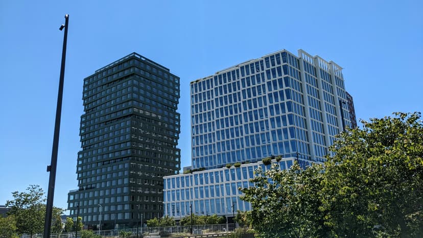 Modern glass and steel office building with blue sky background